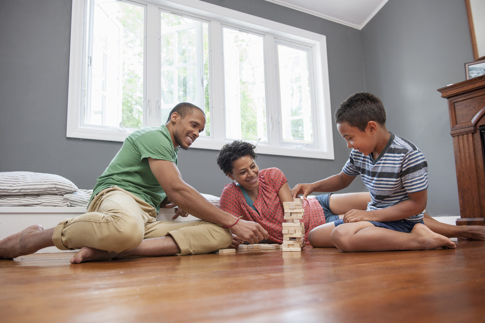 Family on the hardwood floor playing a game at home