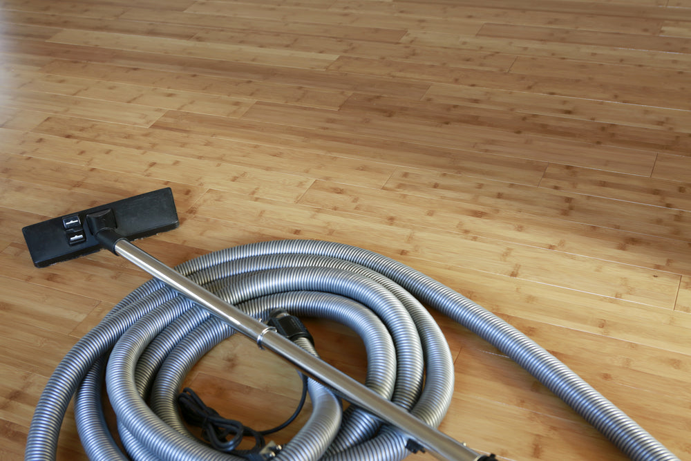 Beautiful bamboo hardwood floor with a central vacuum cleaner