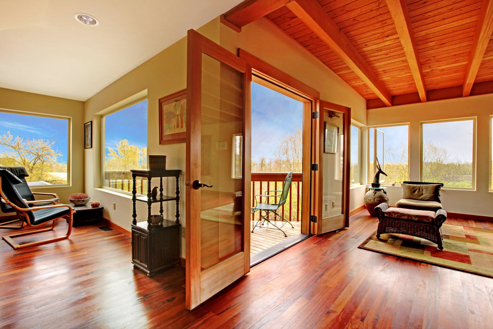 Modern living room with wood ceiling and hardwood floor.