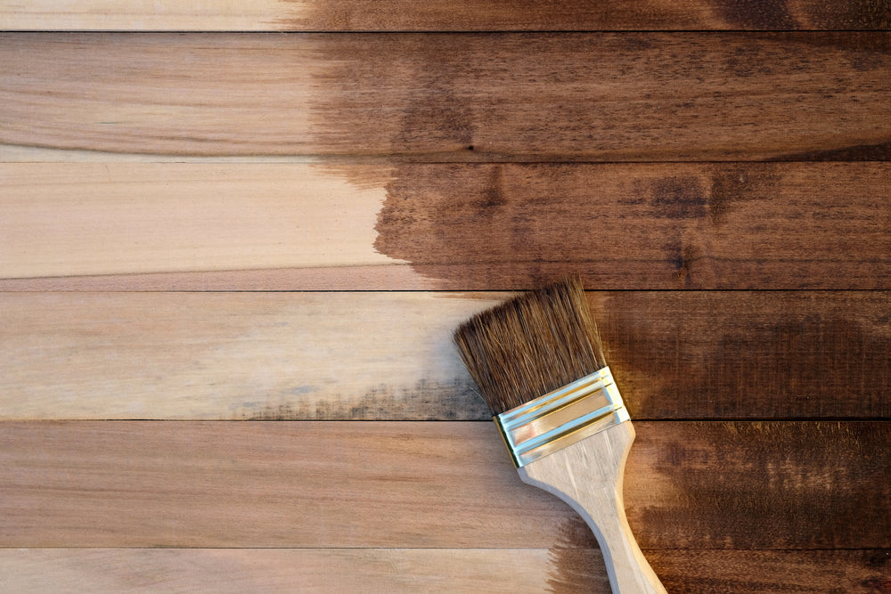 Wooden boards half covered with stain top view.
