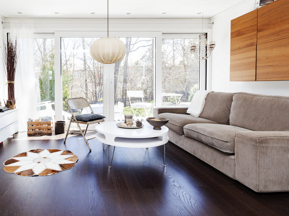 stylish living-room with dark floor and glass doors out to the garden