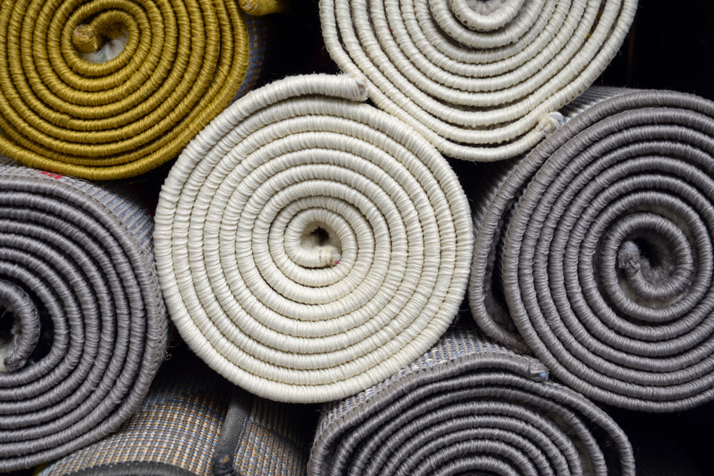 variety selection rolled up rugs shop store